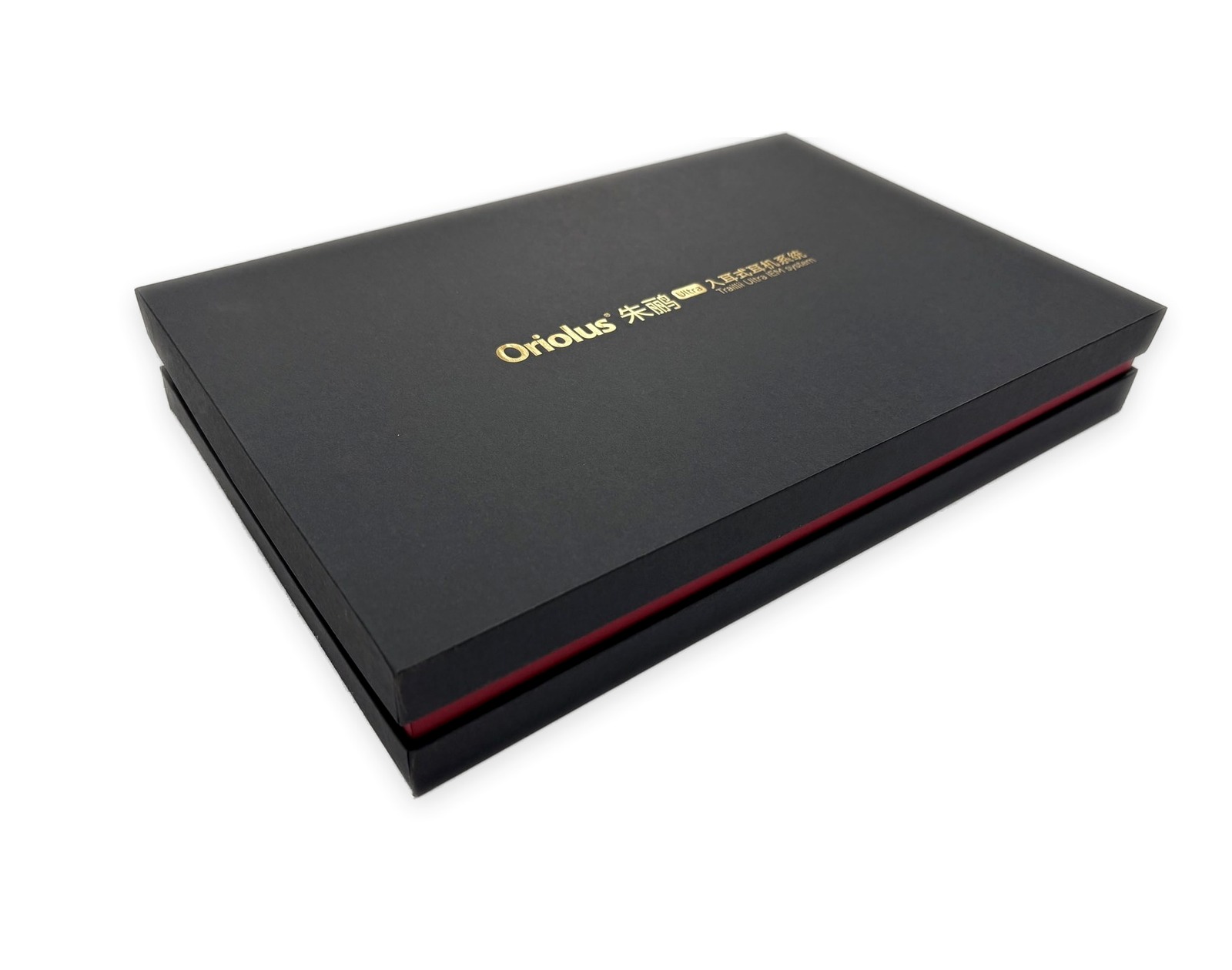 Closed black rigid paper box with red side detail and gold logo