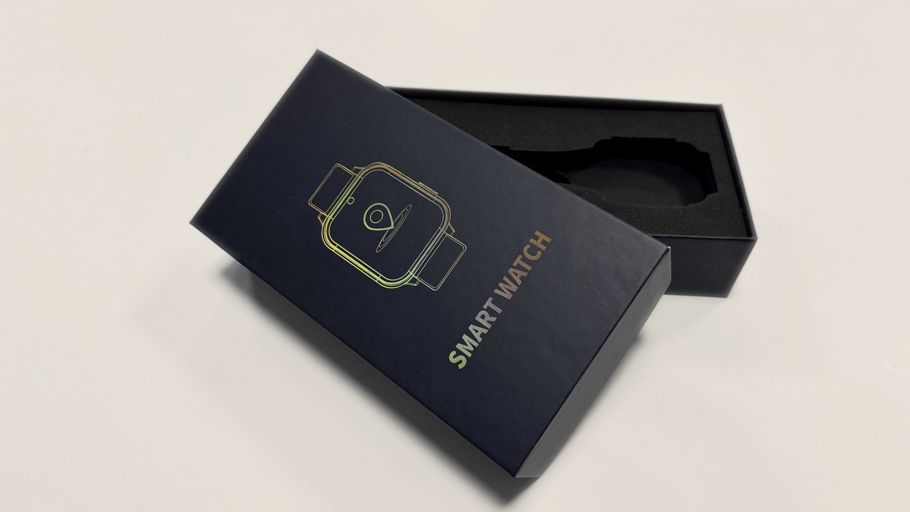 Black lid and base paper box with fitted insert on a warm studio background